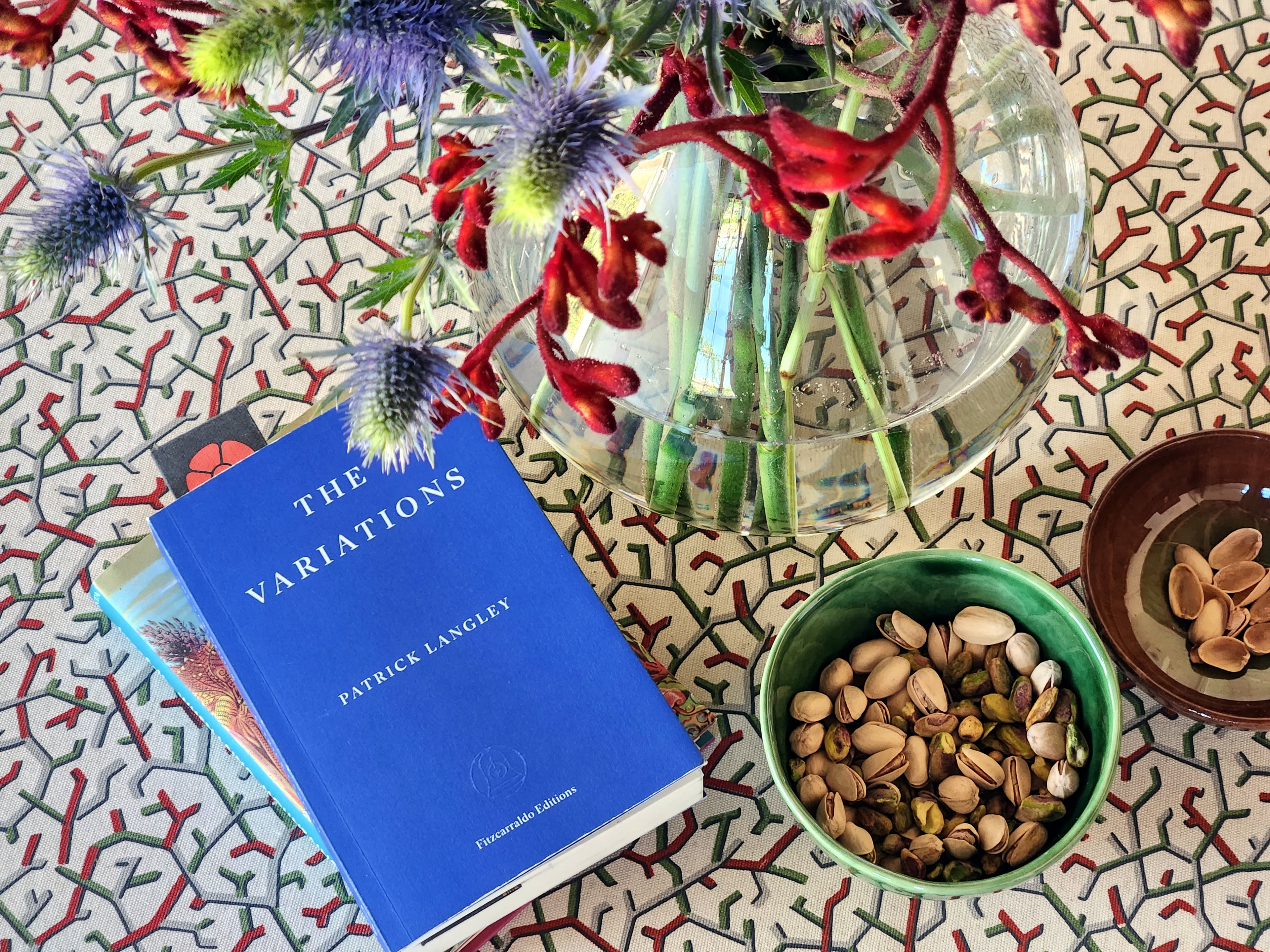 Amaze with a bowl of pistachios and a vase