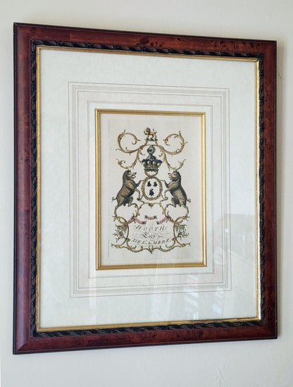 Framed coat of arms on a white wall